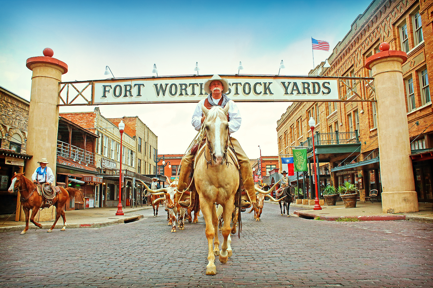 Fort Worth Stockyard cowboy in front of sign.